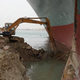 An excavator works to free the Ever Given